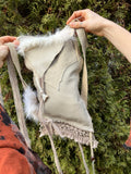 leather purse with cayote fur, feather, bone & cotton details