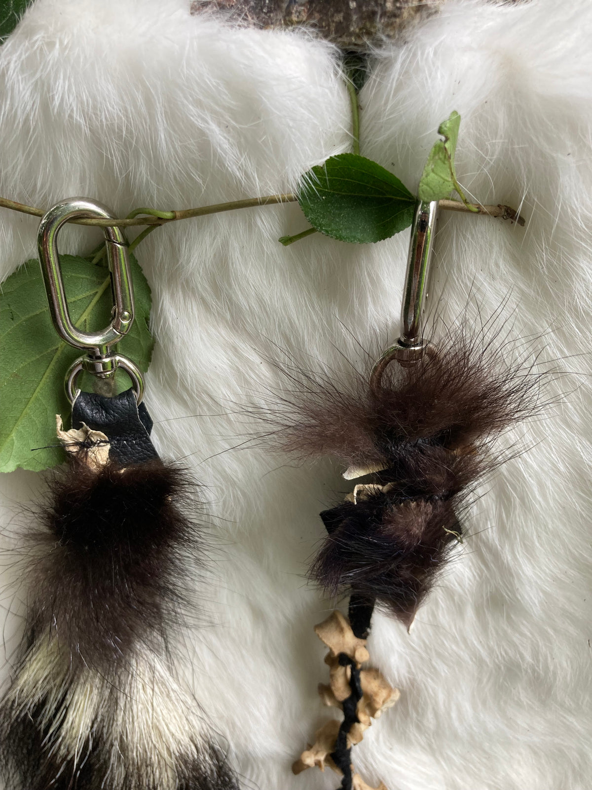skunk tail & vertebrae keychains