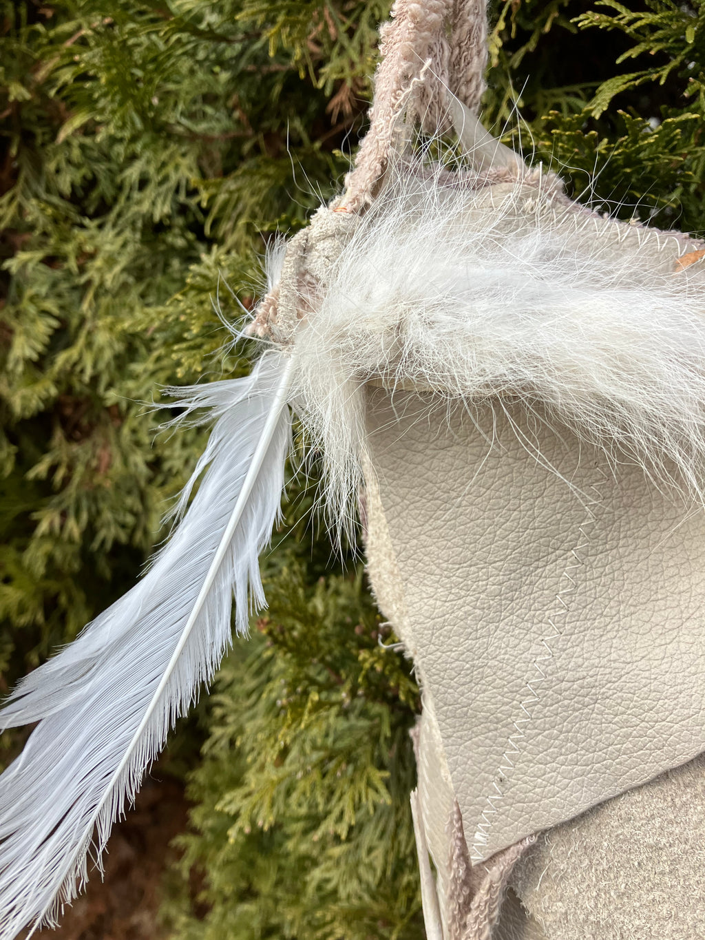leather purse with cayote fur, feather, bone & cotton details
