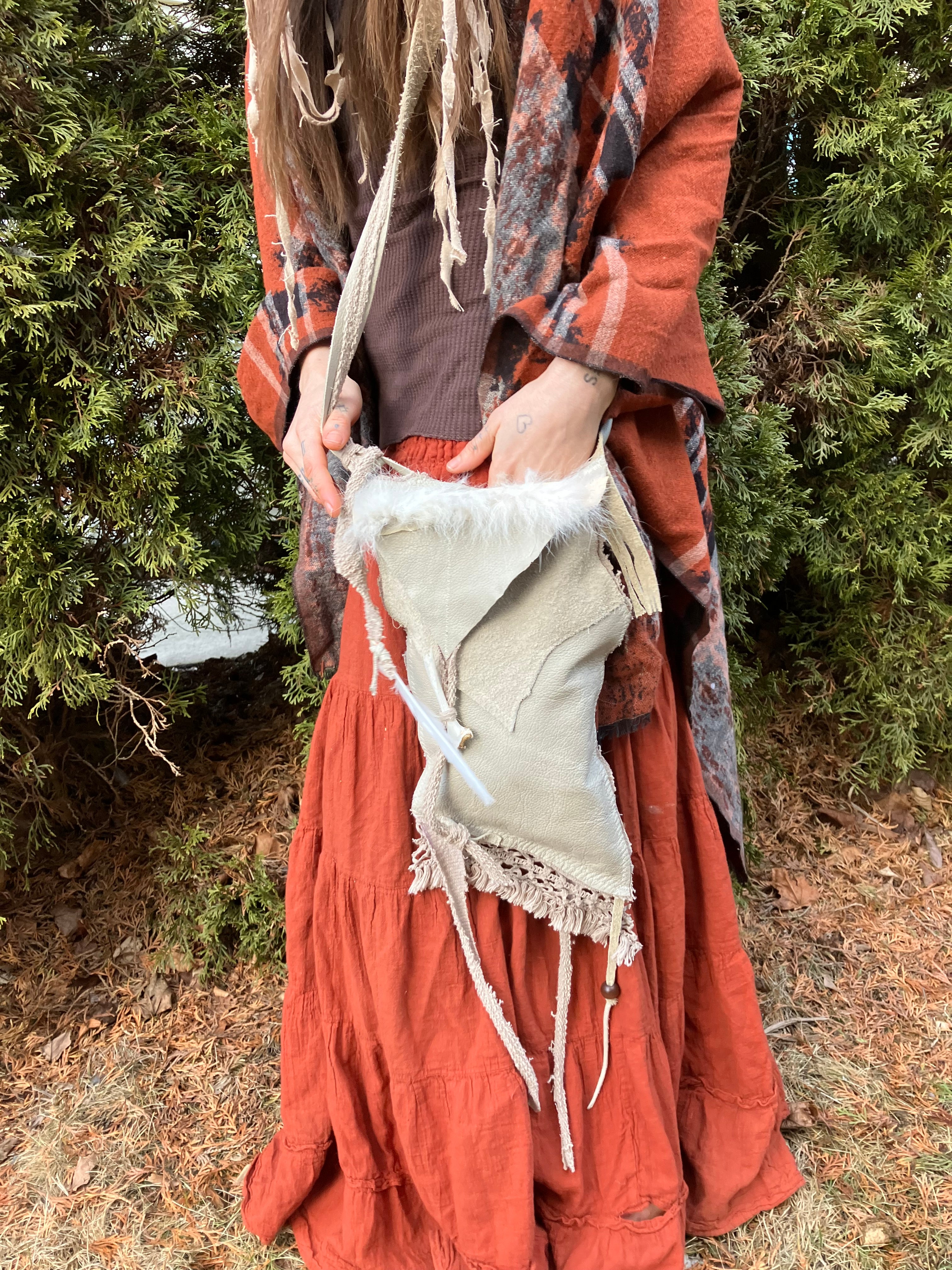 leather purse with cayote fur, feather, bone & cotton details