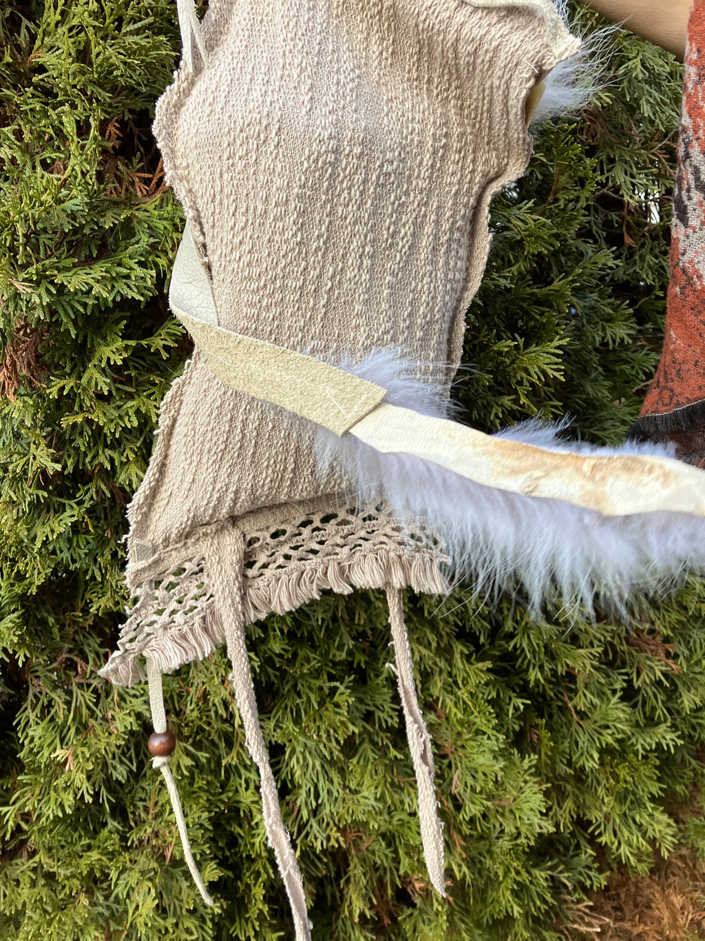 leather purse with cayote fur, feather, bone & cotton details