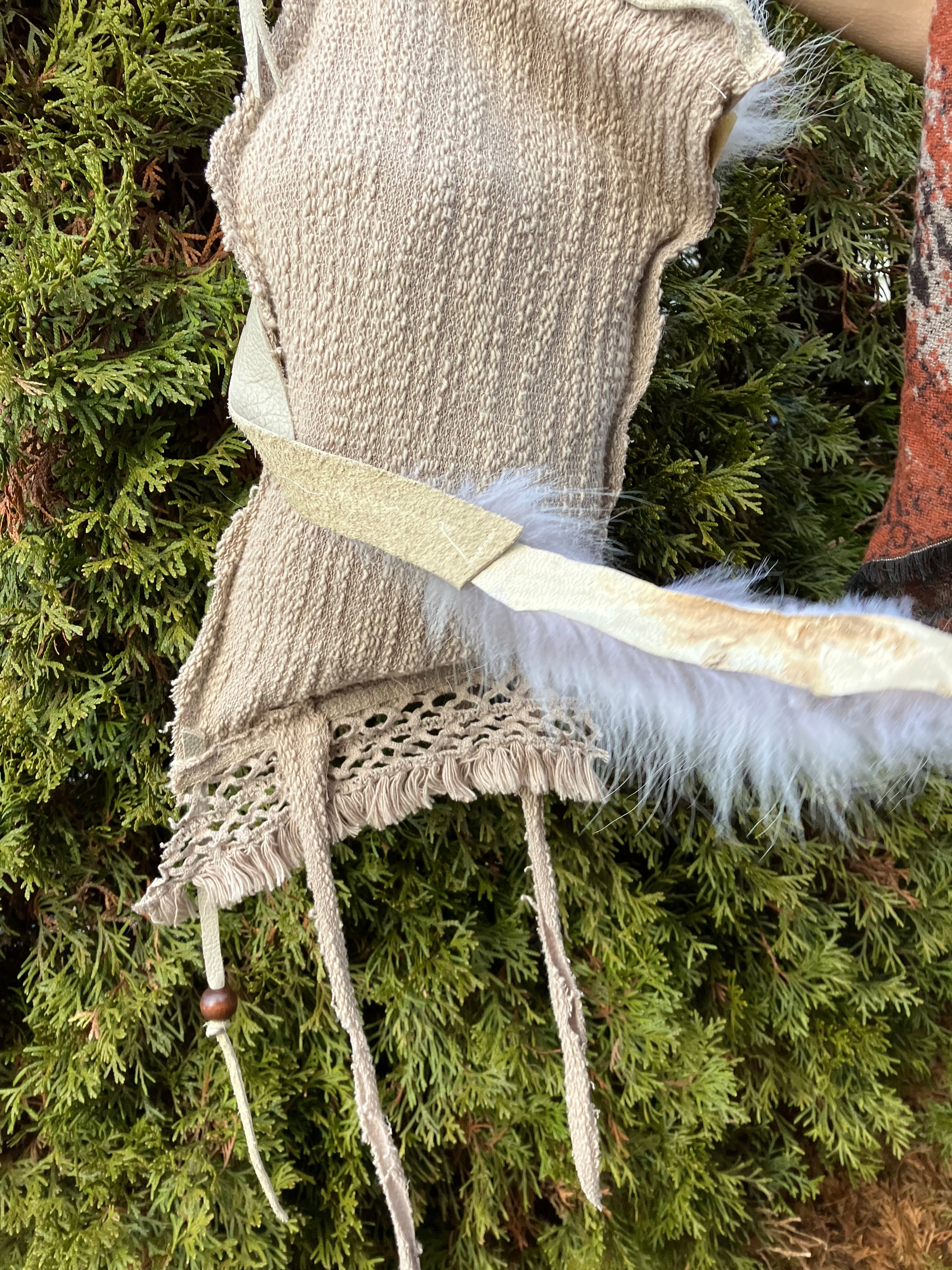 leather purse with cayote fur, feather, bone & cotton details